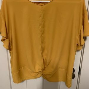 Mustard cropped blouse with knotted front.